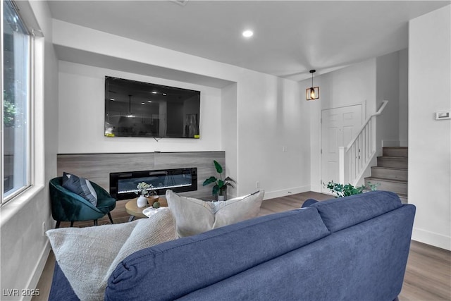 living room featuring hardwood / wood-style flooring and a premium fireplace