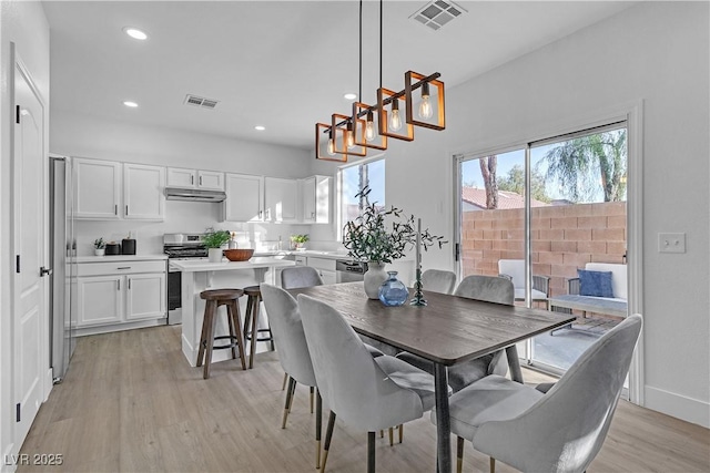 dining area featuring light wood-type flooring