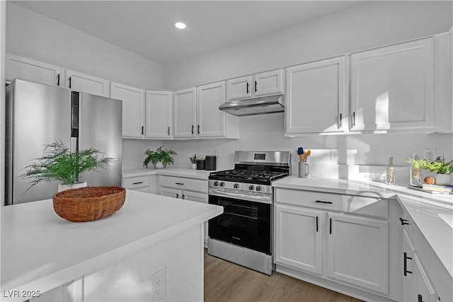 kitchen featuring white cabinetry, appliances with stainless steel finishes, and light wood-type flooring