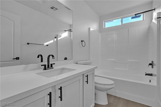 full bathroom with vanity, bathing tub / shower combination, hardwood / wood-style floors, and toilet