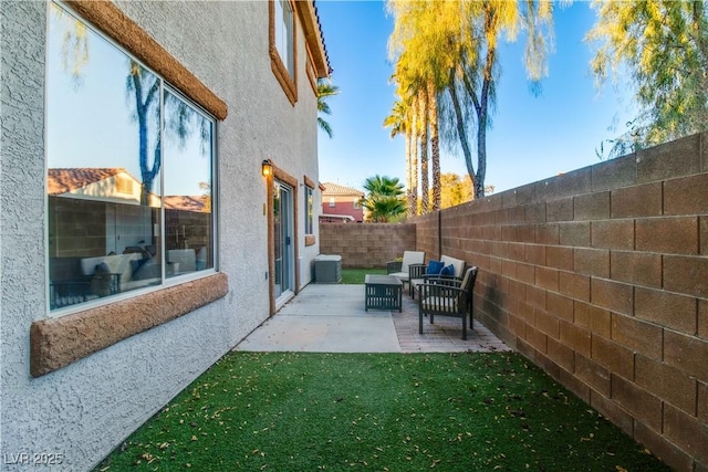 view of yard featuring central air condition unit, a patio area, and outdoor lounge area