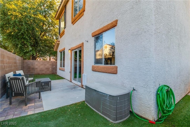 view of property exterior with a patio and outdoor lounge area