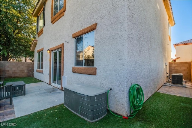 view of side of home featuring a patio and central AC unit