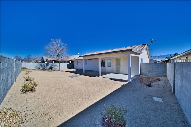 back of property with a patio