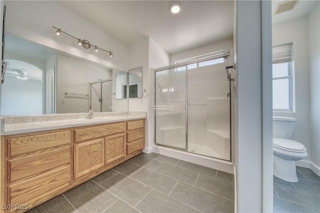 bathroom with toilet, tile patterned flooring, an enclosed shower, and vanity