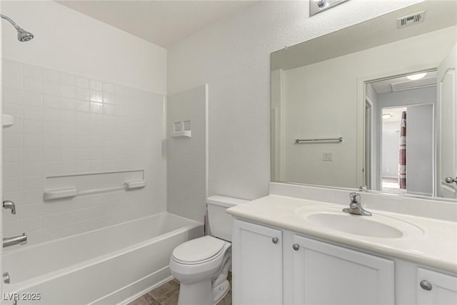 full bathroom featuring shower / tub combination, vanity, and toilet