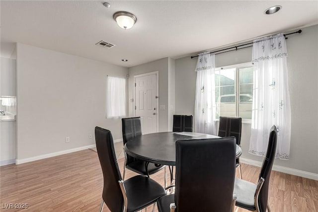 dining space with hardwood / wood-style floors