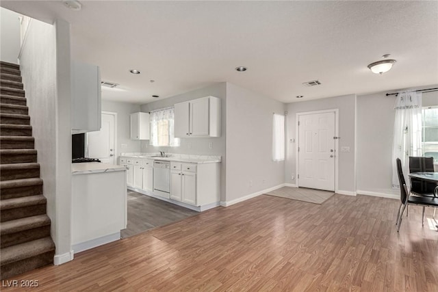 kitchen with white cabinetry, plenty of natural light, dishwasher, and dark wood-type flooring