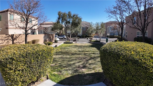 view of property's community featuring a yard