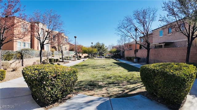 view of home's community with a yard