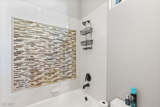 bathroom with decorative backsplash, toilet, and tiled shower / bath