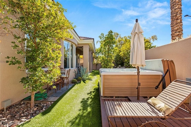 wooden balcony with a wooden deck and a hot tub