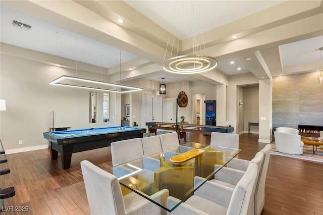 game room featuring wood-type flooring, a tile fireplace, and billiards