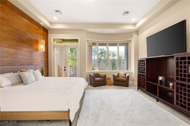 bedroom featuring wooden walls