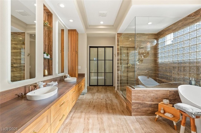 bathroom with vanity, hardwood / wood-style floors, an enclosed shower, and a tray ceiling