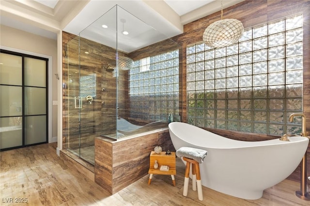 bathroom featuring shower with separate bathtub