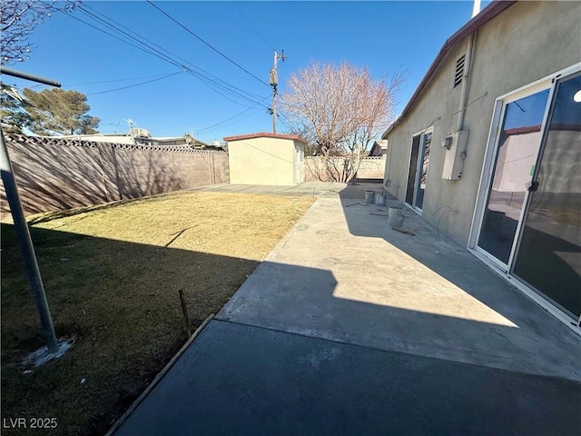 view of yard featuring a fenced backyard, a shed, a patio, and an outdoor structure