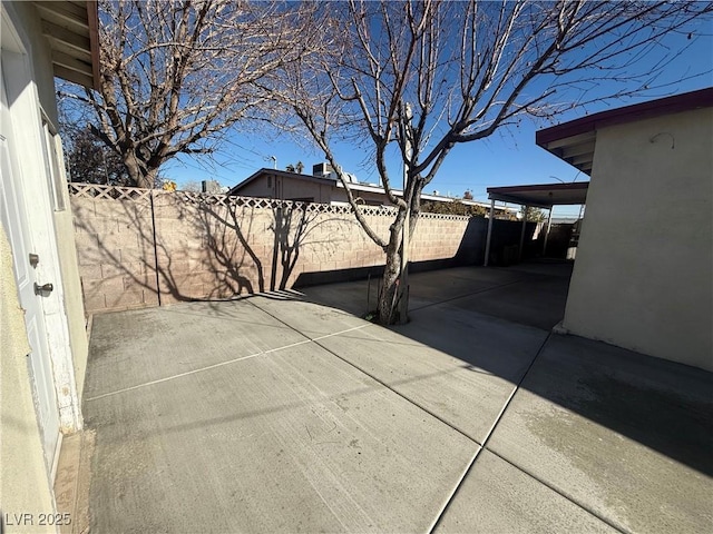 view of patio featuring fence