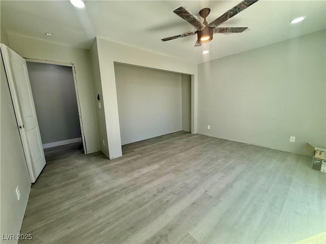 unfurnished bedroom with a ceiling fan, a closet, and wood finished floors