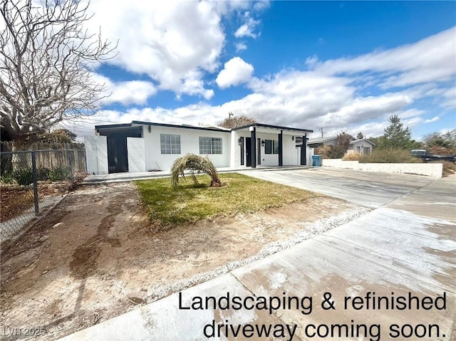 view of front of house featuring fence and stucco siding