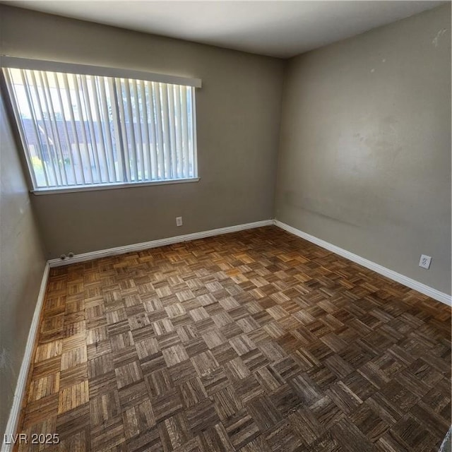 unfurnished room featuring dark parquet floors