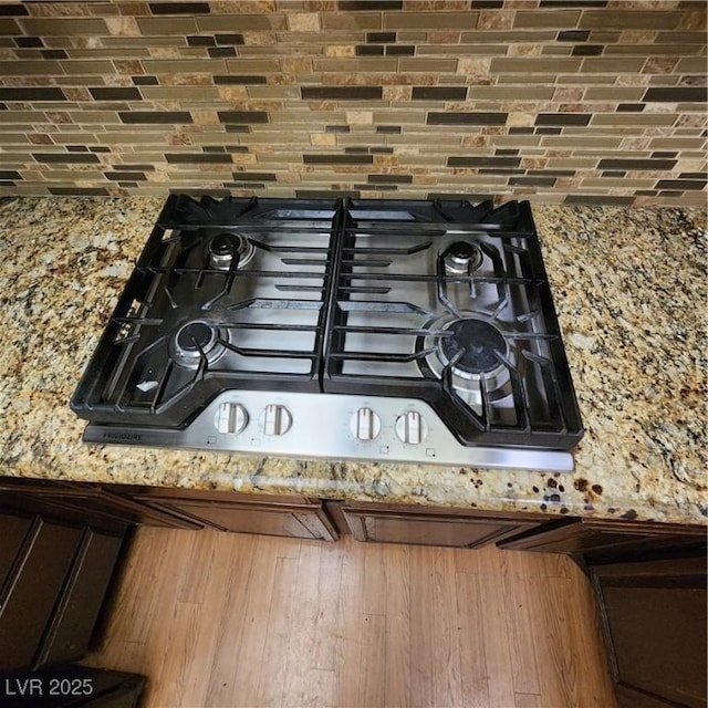 room details featuring gas cooktop and light stone countertops