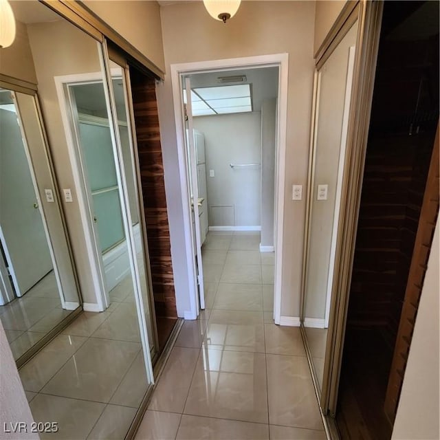 hall featuring light tile patterned floors