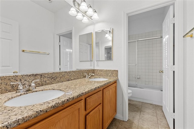 full bathroom featuring bath / shower combo with glass door, toilet, vanity, and tile patterned flooring