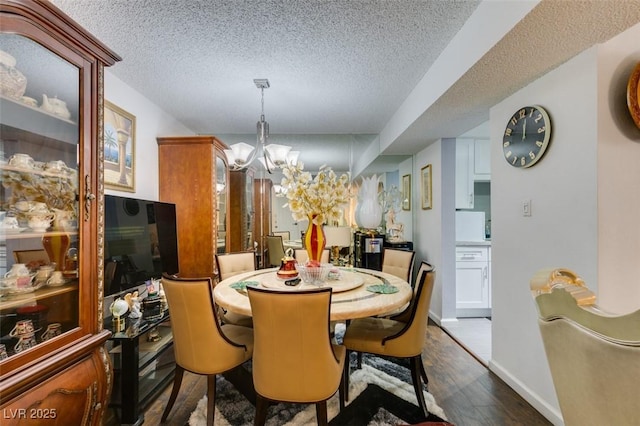 dining room with a notable chandelier, dark hardwood / wood-style floors, and a textured ceiling