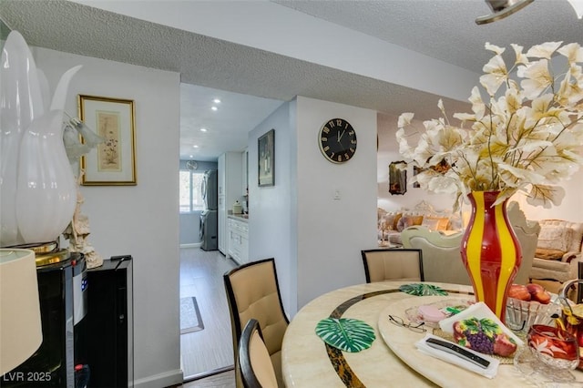 dining area featuring hardwood / wood-style floors and a textured ceiling