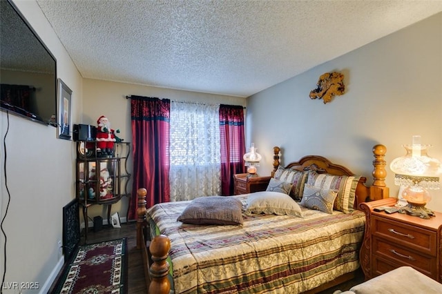 bedroom with dark wood-type flooring and a textured ceiling