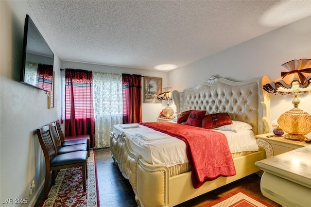 bedroom featuring a textured ceiling and dark hardwood / wood-style floors