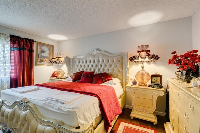 bedroom with dark wood-type flooring and a textured ceiling