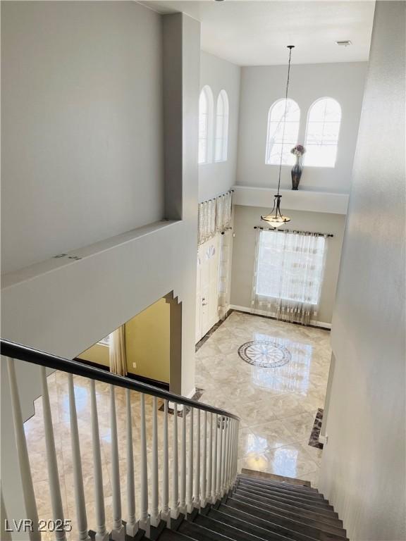 foyer with a towering ceiling and plenty of natural light