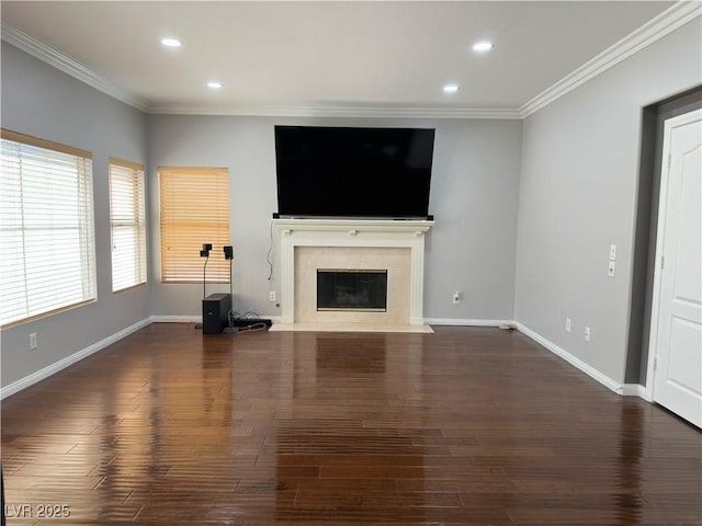 unfurnished living room featuring dark hardwood / wood-style floors, a high end fireplace, and ornamental molding