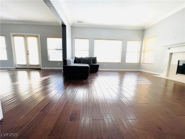 unfurnished living room with crown molding and dark wood-type flooring