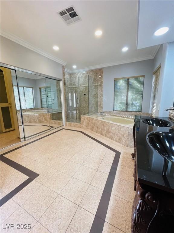 bathroom with tile patterned floors, ornamental molding, and plus walk in shower