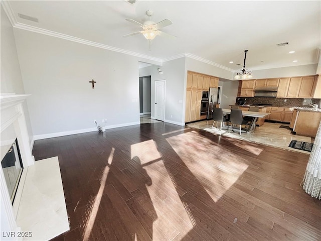 living room with crown molding, ceiling fan with notable chandelier, and dark hardwood / wood-style flooring