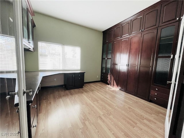 interior space with light hardwood / wood-style floors and built in desk