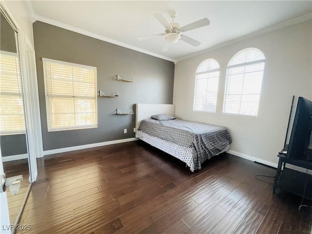 bedroom with ceiling fan, dark hardwood / wood-style floors, and crown molding