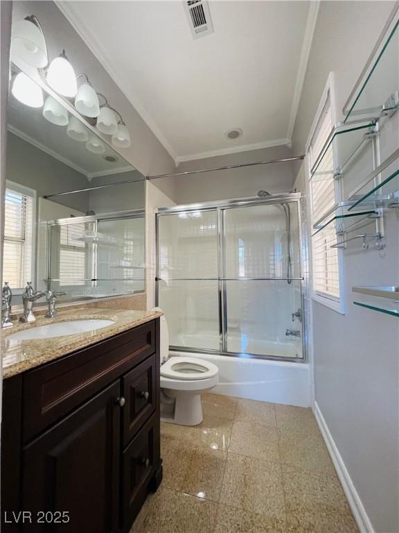 full bathroom with enclosed tub / shower combo, vanity, toilet, and a healthy amount of sunlight