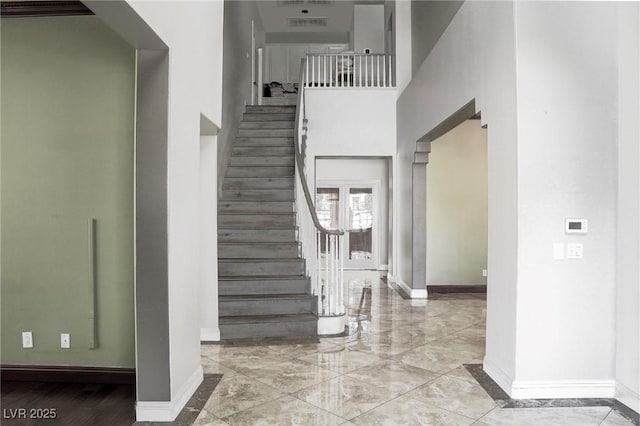 stairs featuring a towering ceiling