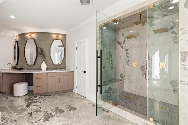 bathroom with crown molding, a shower with shower door, and vanity