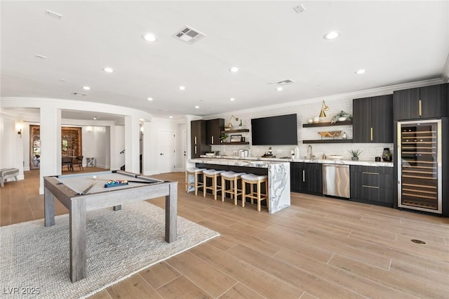 playroom with crown molding, billiards, wet bar, and beverage cooler