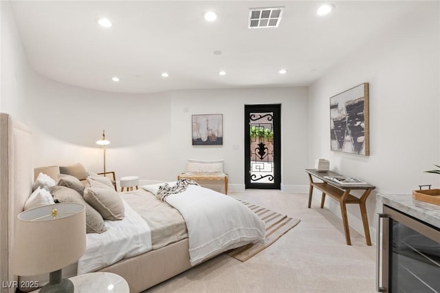 carpeted bedroom with beverage cooler