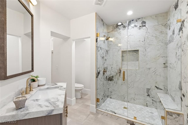 bathroom featuring toilet, vanity, and walk in shower