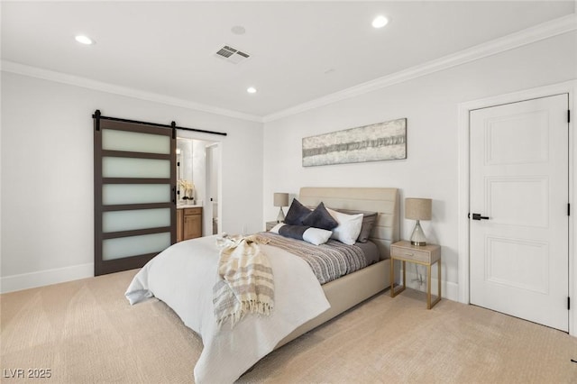 carpeted bedroom featuring a barn door, ornamental molding, and ensuite bath