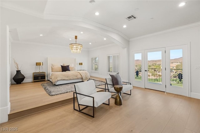 bedroom with light hardwood / wood-style floors, access to exterior, crown molding, and a notable chandelier