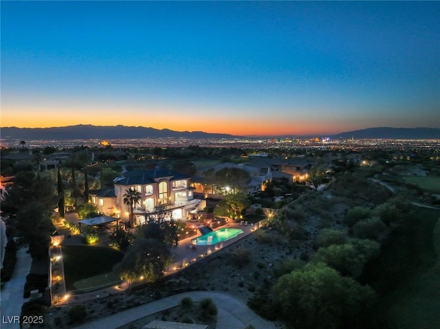 aerial view at dusk featuring a mountain view