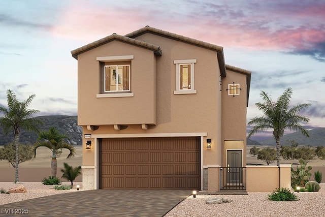 view of front facade featuring a mountain view and a garage